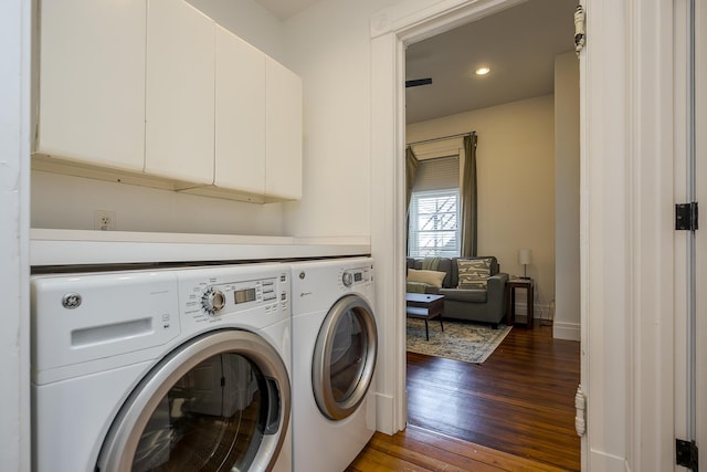 laundry area featuring independent washer and dryer, recessed lighting, hardwood / wood-style floors, baseboards, and cabinet space