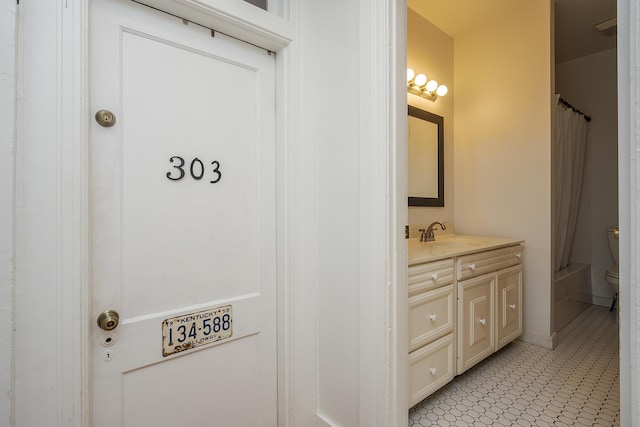 full bath featuring toilet and vanity