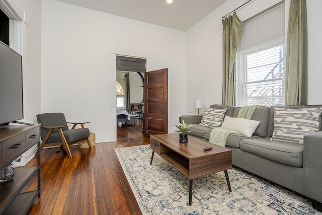 living area with wood-type flooring and baseboards