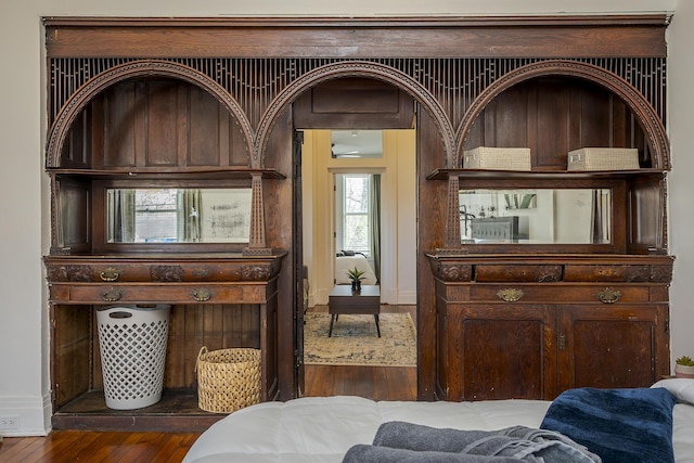 interior space with baseboards and wood finished floors