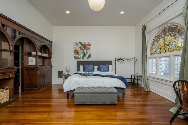 bedroom featuring wood finished floors, baseboards, and recessed lighting