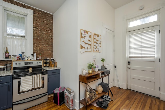 kitchen with stainless steel range with electric stovetop, wood-type flooring, and gray cabinets