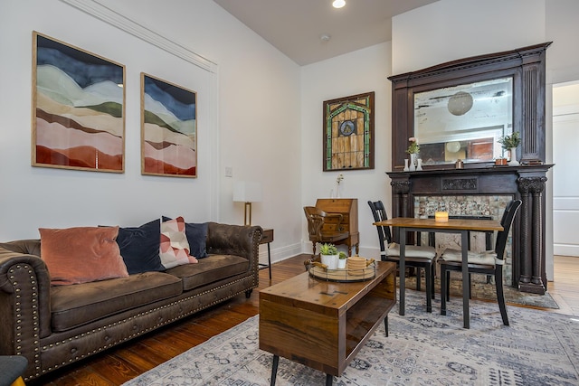 living room with recessed lighting, baseboards, and wood finished floors