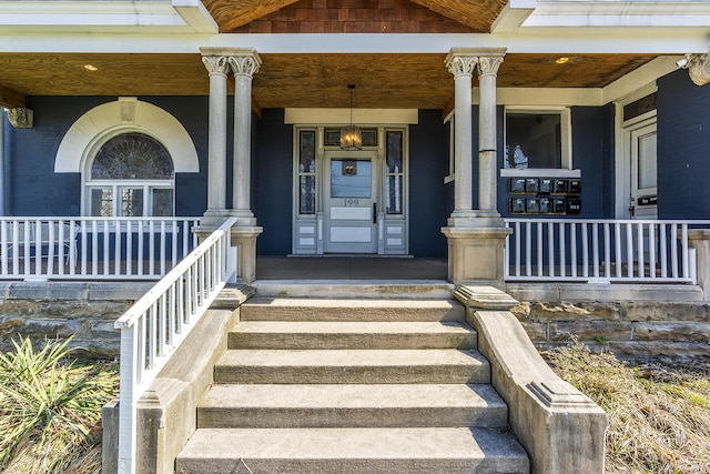 view of exterior entry with a porch