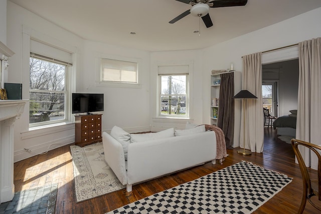 living area with ceiling fan and hardwood / wood-style floors