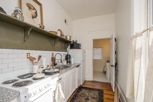 kitchen with white appliances, open shelves, white cabinets, light wood finished floors, and a sink