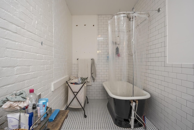 bathroom featuring a freestanding bath, tile walls, tiled shower, and tile patterned floors