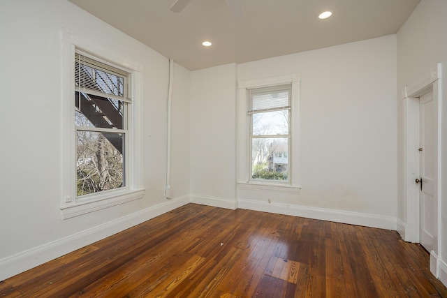 empty room featuring recessed lighting, baseboards, and hardwood / wood-style flooring