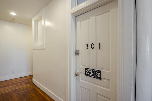room details featuring baseboards, recessed lighting, and wood finished floors