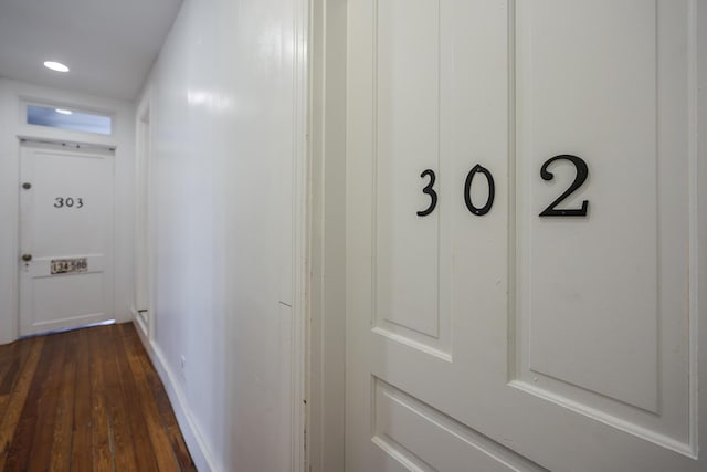 corridor featuring dark wood-style flooring and recessed lighting