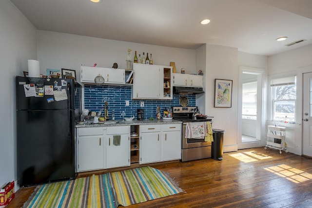 kitchen with stainless steel electric range oven, open shelves, exhaust hood, a sink, and freestanding refrigerator