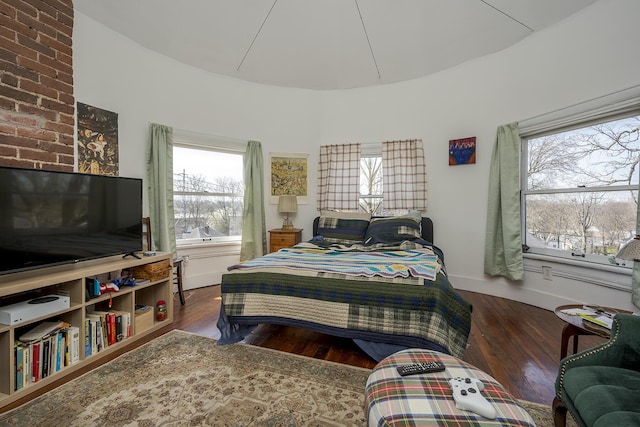 bedroom featuring baseboards and hardwood / wood-style flooring