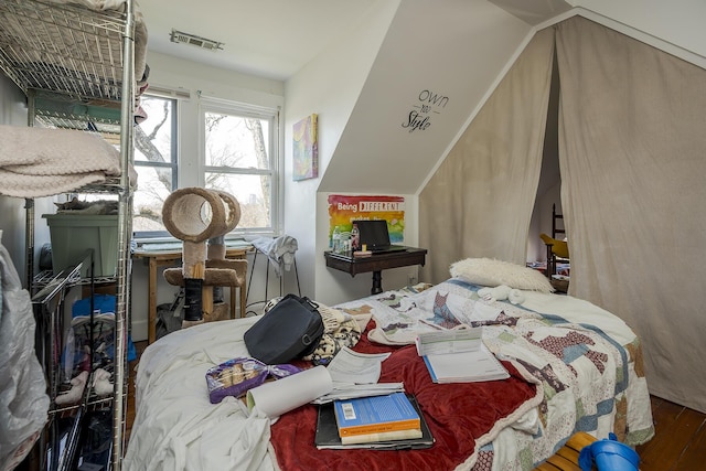 bedroom with visible vents and wood finished floors