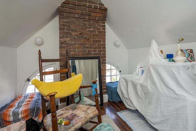 bedroom featuring wood finished floors and vaulted ceiling