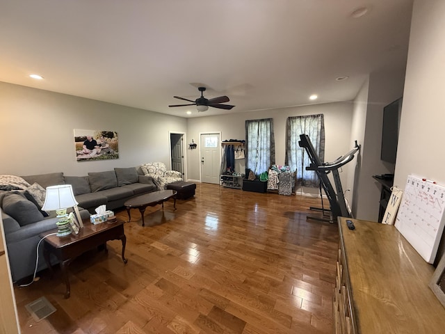 living area featuring wood finished floors, ceiling fan, and recessed lighting