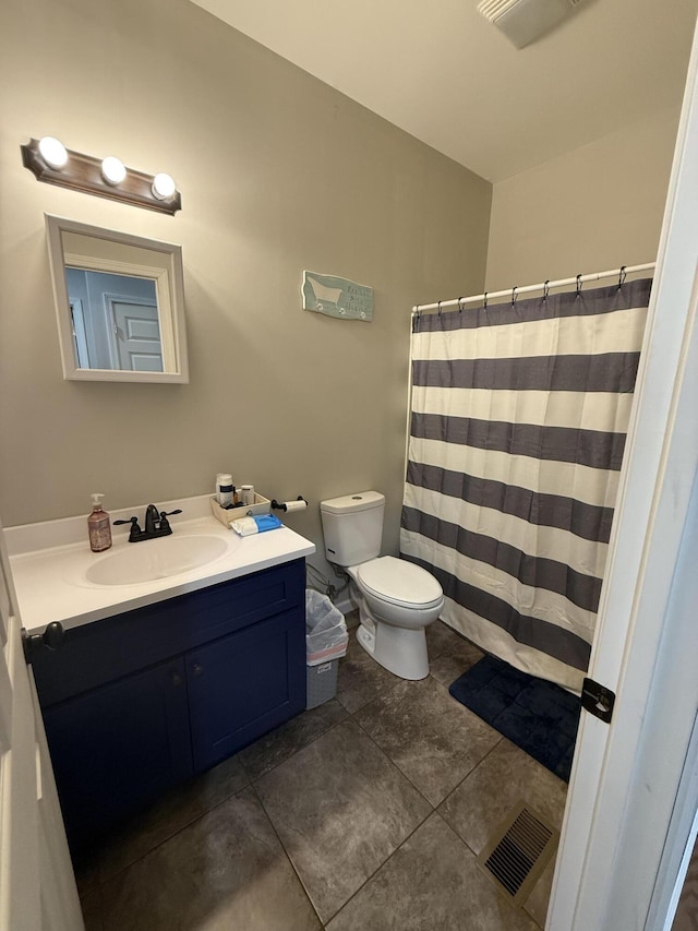 bathroom featuring visible vents, toilet, a shower with shower curtain, and vanity