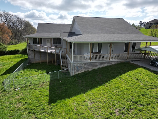 back of house featuring a yard, stairs, fence private yard, and a shingled roof