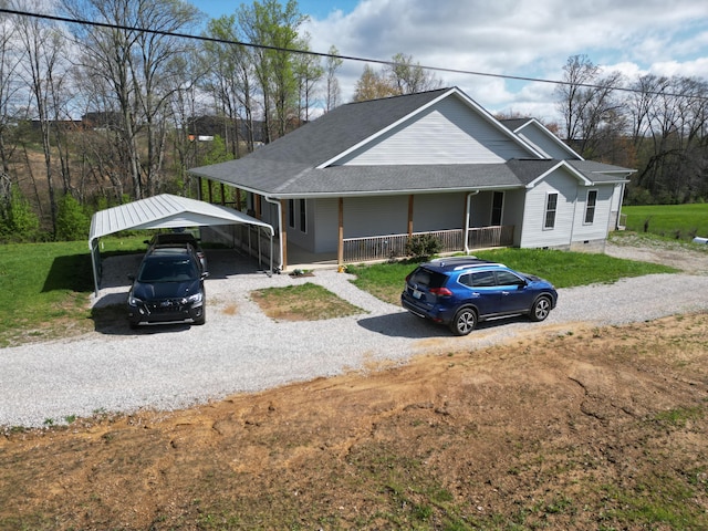 view of front of house with a carport, crawl space, a front lawn, gravel driveway, and covered porch