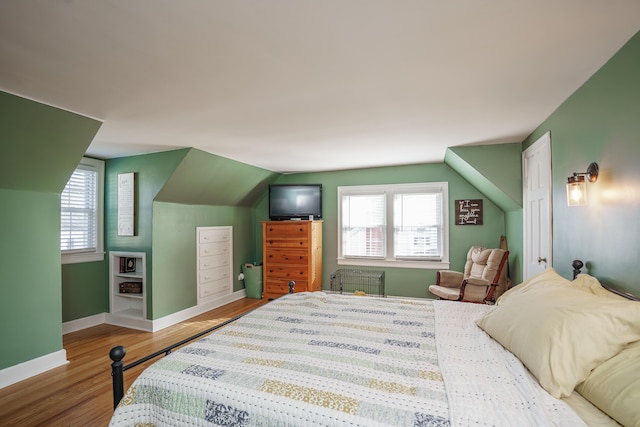 5 Bath Ave, Owingsville, KY 40360 - bedroom with radiator heating unit, multiple windows, baseboards, and wood finished floors
