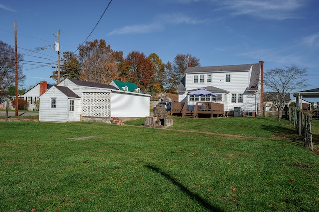 5 Bath Ave, Owingsville, KY 40360 - back of house featuring fence, an outdoor structure, a deck, and a lawn