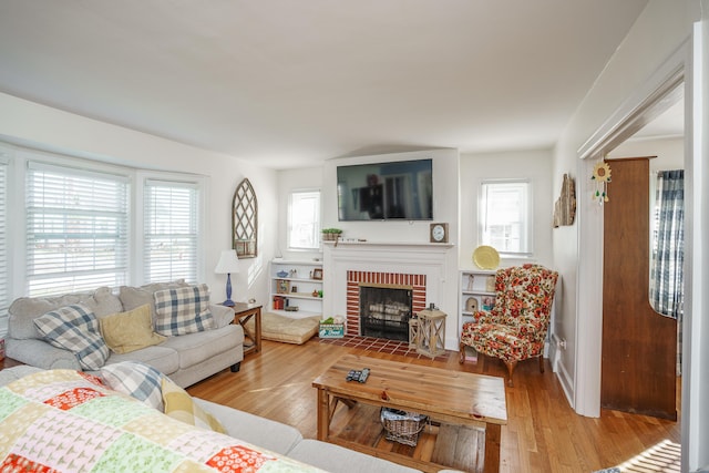 5 Bath Ave, Owingsville, KY 40360 - living room featuring light wood-style flooring and a brick fireplace
