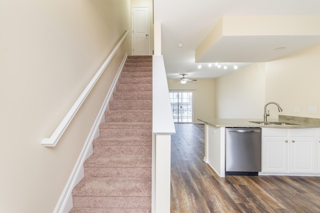 stairs featuring wood finished floors and baseboards