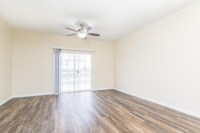 spare room with baseboards, wood finished floors, and ceiling fan