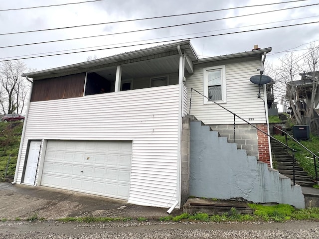 131 Keller St, Cumberland, KY 40823 - view of side of property featuring stairway, a garage, and aphalt driveway