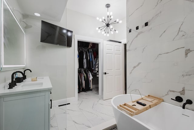 211 Eric Dr, Richmond, KY 40475 - bathroom featuring marble finish floor, double vanity, a sink, a soaking tub, and a notable chandelier