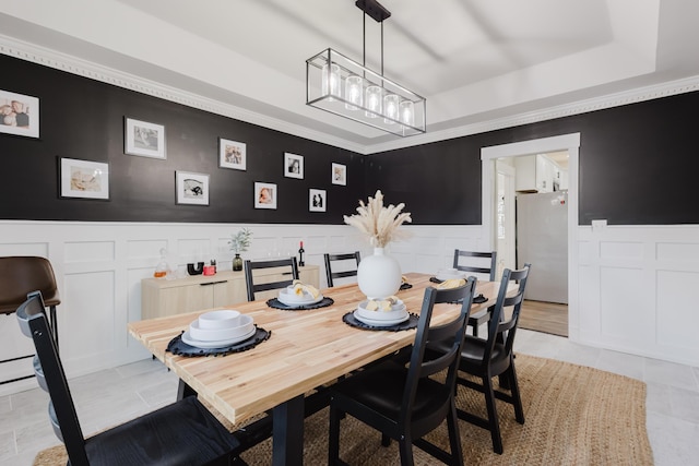 211 Eric Dr, Richmond, KY 40475 - dining room featuring a wainscoted wall, a tray ceiling, light tile patterned floors, a decorative wall, and a notable chandelier