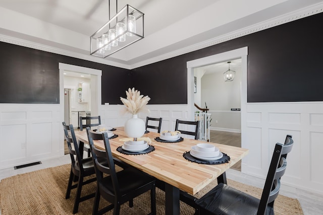 211 Eric Dr, Richmond, KY 40475 - dining space featuring a decorative wall, a wainscoted wall, and an inviting chandelier