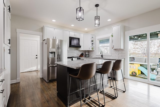 211 Eric Dr, Richmond, KY 40475 - kitchen featuring custom exhaust hood, a sink, stainless steel appliances, backsplash, and white cabinetry