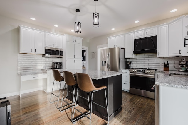 211 Eric Dr, Richmond, KY 40475 - kitchen with white cabinetry, appliances with stainless steel finishes, tasteful backsplash, and range hood
