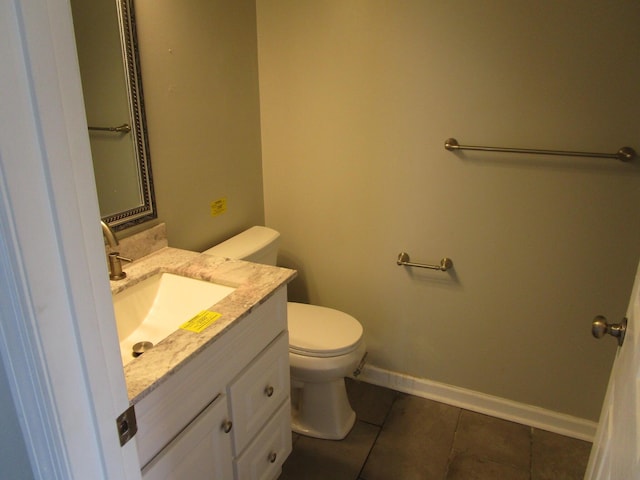 half bath featuring vanity, toilet, baseboards, and tile patterned flooring