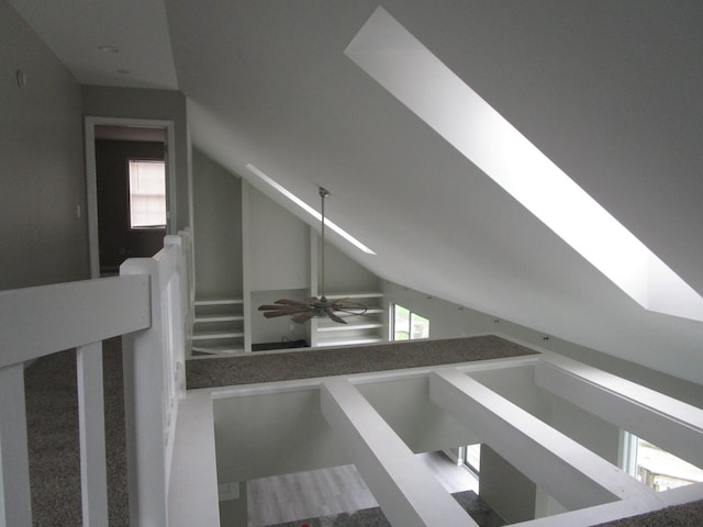bonus room featuring a ceiling fan and vaulted ceiling with skylight