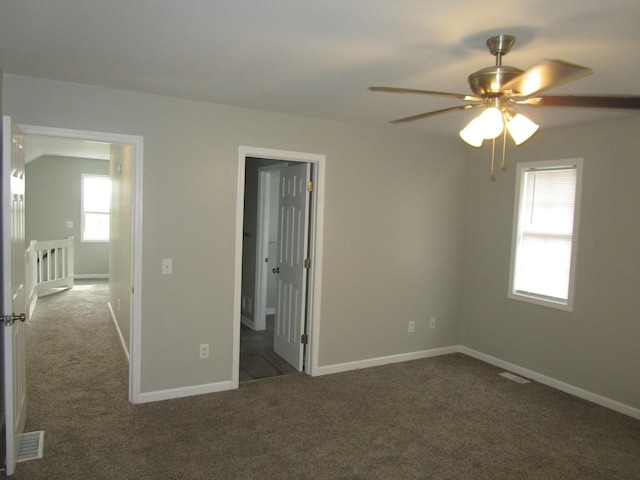 unfurnished bedroom with carpet flooring, visible vents, and baseboards