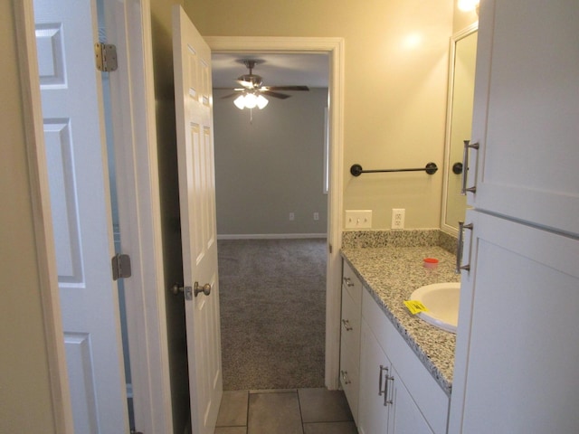bathroom with tile patterned flooring, vanity, and ceiling fan