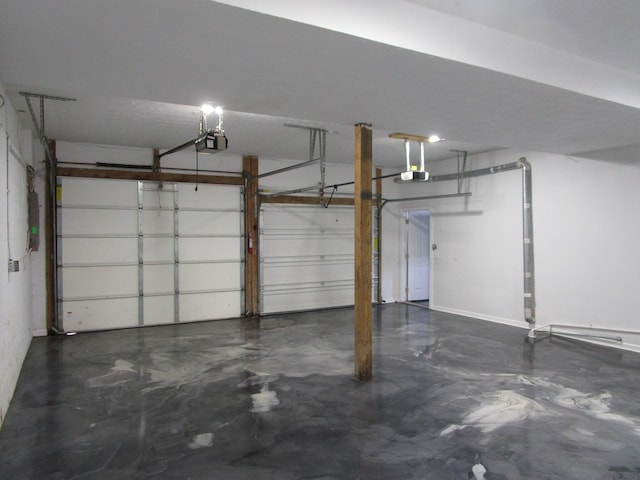 garage with baseboards and a garage door opener
