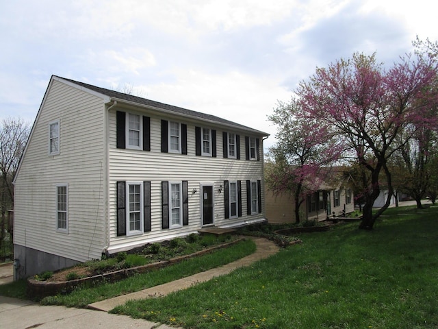 colonial home with a front lawn