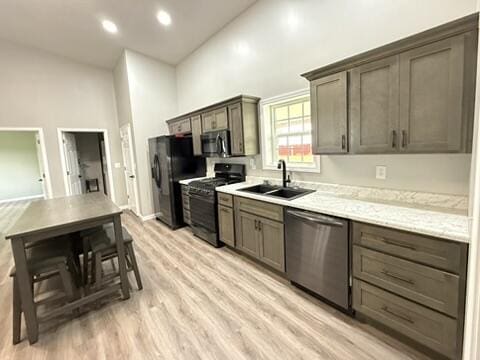 1476 Gosser Ridge Rd, Liberty, KY 42539 - kitchen featuring black appliances, light wood-style floors, high vaulted ceiling, and light countertops