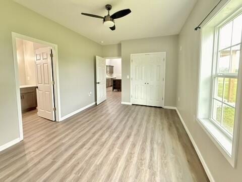 1476 Gosser Ridge Rd, Liberty, KY 42539 - unfurnished bedroom with light wood-style floors, a closet, a ceiling fan, and ensuite bathroom