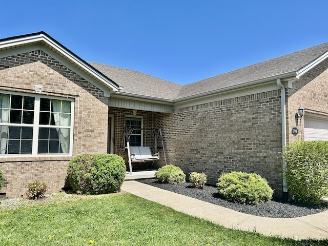 199 Newport Ln, Berea, KY 40403 - entrance to property featuring brick siding, roof with shingles, and a lawn