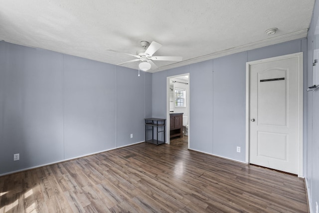 unfurnished room with wood finished floors, a textured ceiling, and ceiling fan