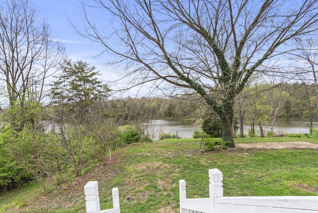 view of yard with a water view and a wooded view
