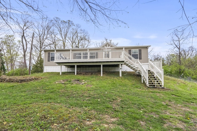 back of house with a lawn, a wooden deck, and stairway