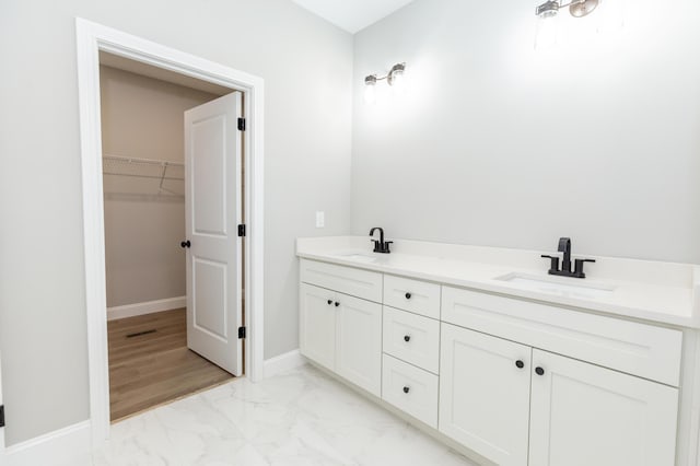 437 Boones Creek Rd, Lancaster, KY 40444 - bathroom with a sink, a spacious closet, marble finish floor, and baseboards