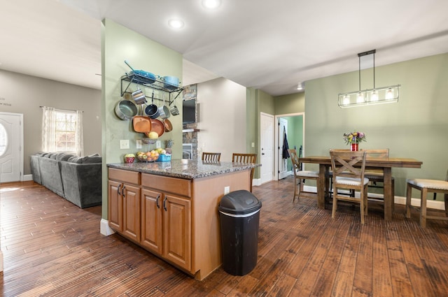 88 Hawkins Ln, Clay City, KY 40312 - kitchen featuring stone counters, baseboards, pendant lighting, and dark wood-style floors
