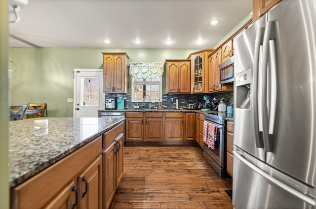 88 Hawkins Ln, Clay City, KY 40312 - kitchen featuring tasteful backsplash, a sink, stainless steel appliances, brown cabinets, and dark wood-style floors