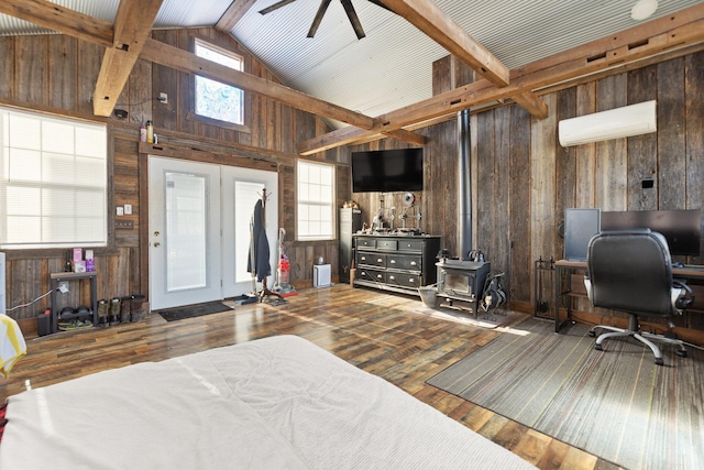 88 Hawkins Ln, Clay City, KY 40312 - bedroom with wooden walls, beamed ceiling, a wood stove, and a wall mounted air conditioner