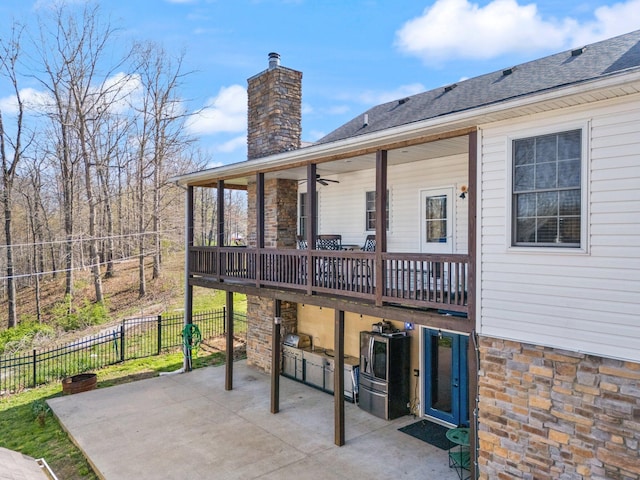 88 Hawkins Ln, Clay City, KY 40312 - rear view of house with fence, stone siding, a patio, and a chimney
